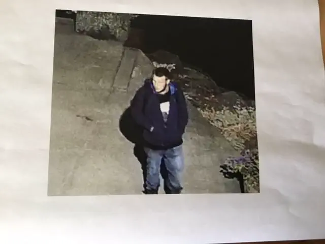 A black and white screen cap from security footage showing one of the suspects involved in the theft of Laird's boat.