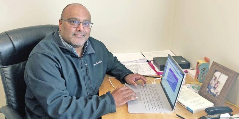 A picture of Dr. Armogam at his desk