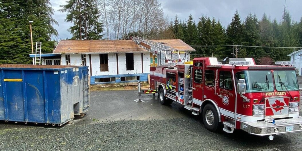 A fire truck sits outside an old building