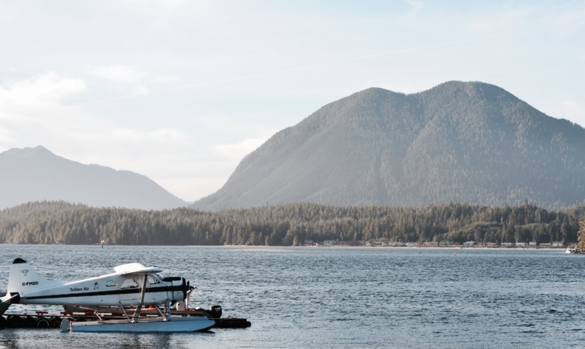 Float plane on water in front of steep hills