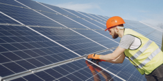 Young engineer checking maintenance of solar panels