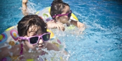 2 girls swimming during daytime