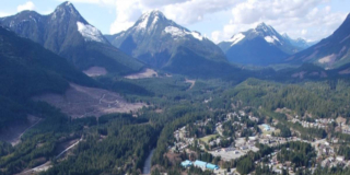 An aerial view of Gold River with the mountains in the background.