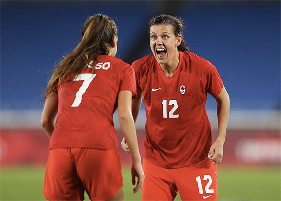 Christine Sinclair celebrates with team mate Julia Grosso after the team wins.