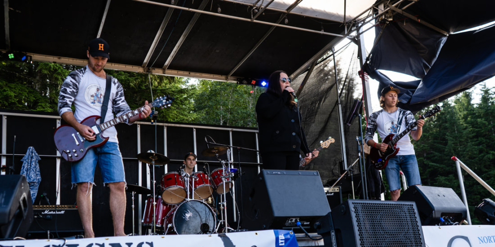 A band plays on an outdoor stage.