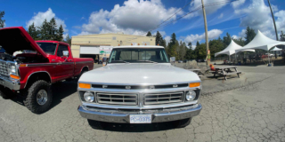 The front of a vintage Ford F150 on a sunny day.