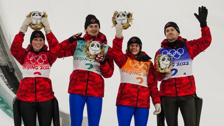 Alexandria Loutitt, Matthew Soukup, Abigail Strate and Mackenzie Boyd-Clowes stand with their Olympic medals in mixed ski jumping.