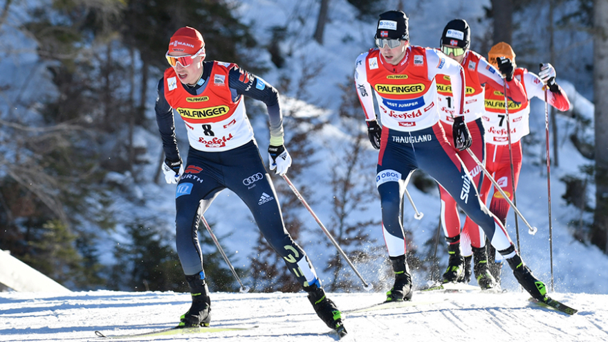 A group of cross-country skiers compete in Nordic Combined.