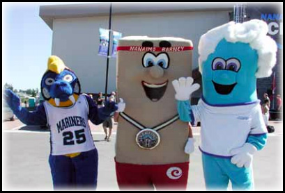 Vancouver Island University’s Blue Thunder, Nanaimo Barney, and Waverly the Wave mascots dance in a parking lot on a sunny day.