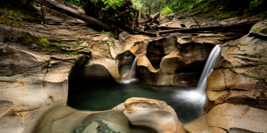 Potholes filled with water by waterfalls in Cumberland