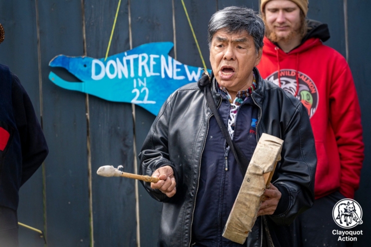 Charles Fergus Billy drums in front of a sign that reads "don't renew 22."