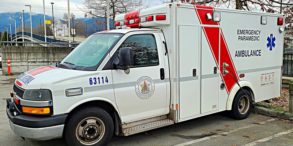 A British Columbia ambulance sits parked on a cloudy day. Is this the only ambulance in Port McNeill?