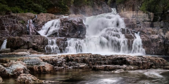 Myra Falls in Strathcona Park on a cloudy day.