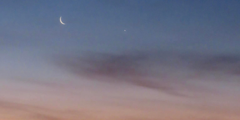 A crescent moon at sunrise.