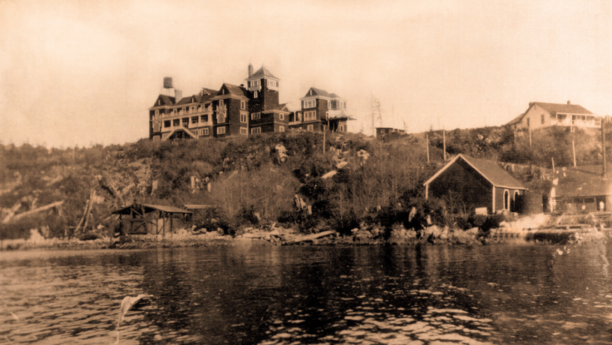 A sepia-toned photo of the original Bamfield Cable House in the early 1900s.