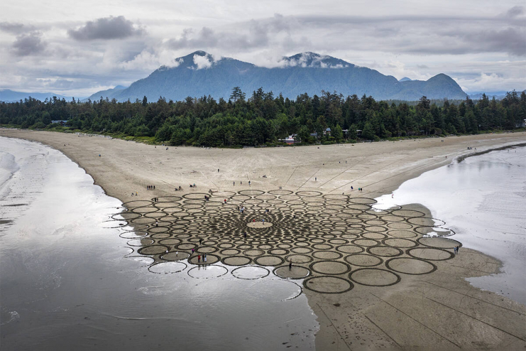 Jim Denevan's artwork on Chesterman Beach slowly washes back into the ocean.