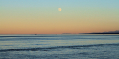 A full moon rises over the ocean off of Campbell River.