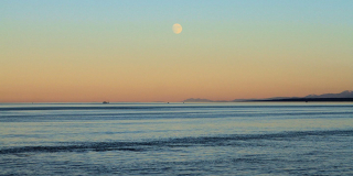 A full moon rises over the ocean off of Campbell River.