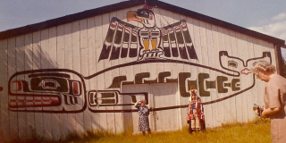 A scan of an old photo of people outside the K'omoks big house.